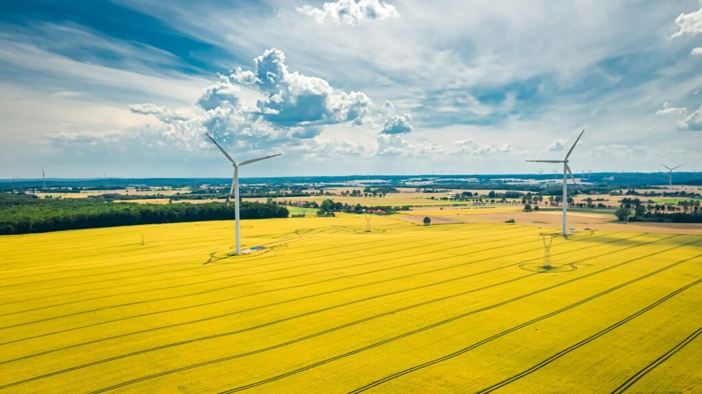 Aerial view of wind turbines on golden field, aerial view